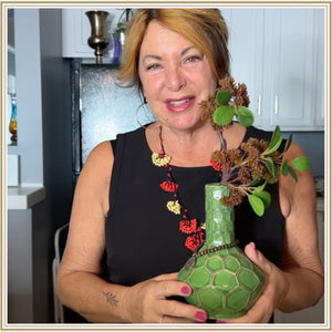 Doreen smiling with green Turtle My Bud Vase bong in hand