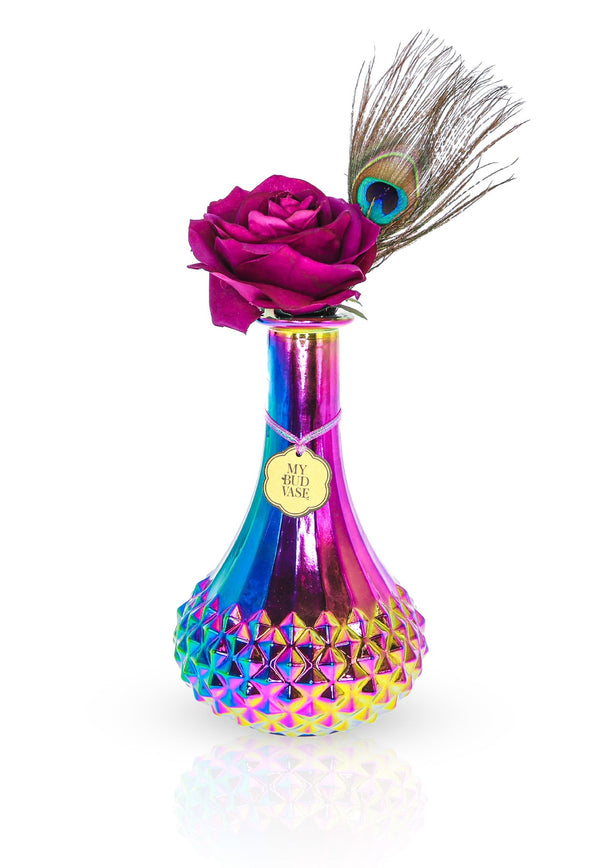 Beautiful iridescent bong that looks like a flower vase. Made to look like carnival glass this vase shines in different colors. Comes with a purple bowl or slide to match and a peacock feather and faux purple rose to disguise your bong into a vase.  