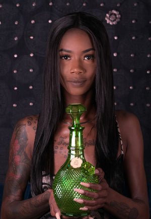 woman holding glass vase bong