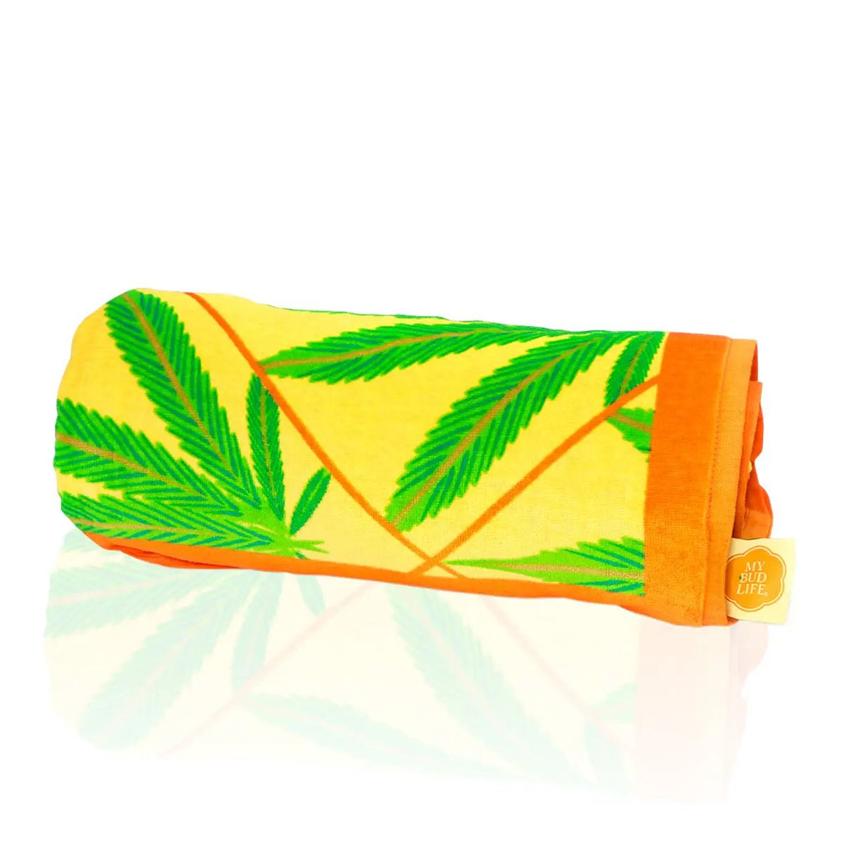 Luxurious big beach towel with bright colors and green bud leaves rolled up.